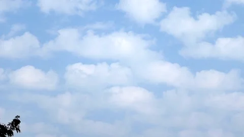 Soft white clouds floating across a clear blue daytime sky Stock Footage 330702797