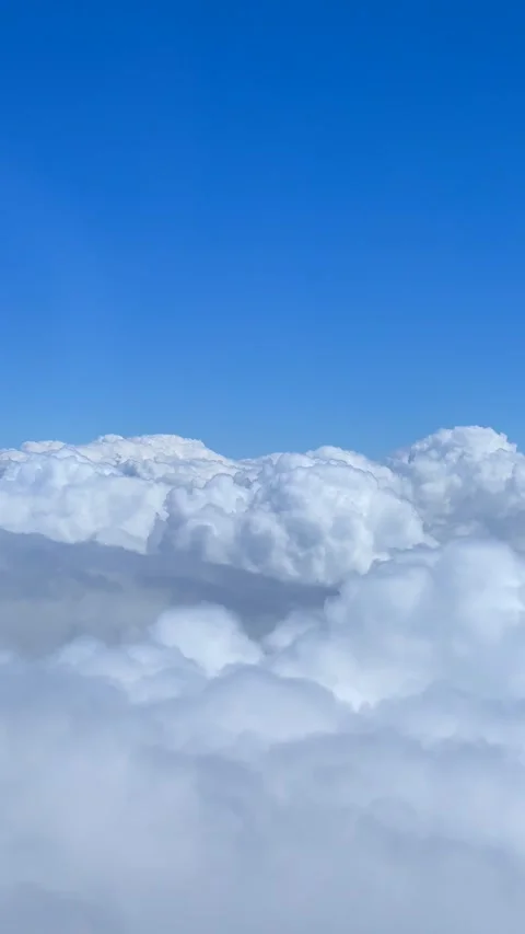 Soft White Clouds Floating Beneath Clear Blue Sky Seen from High Altitude Stock Footage 310210041