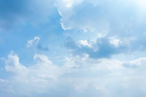 Soft white clouds floating in a bright blue sky during a sunny day Stock Photos