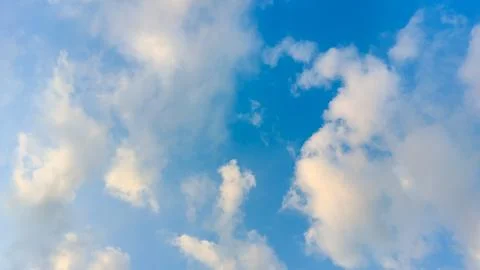 Soft white clouds floating in a vibrant blue sky Stock Photos