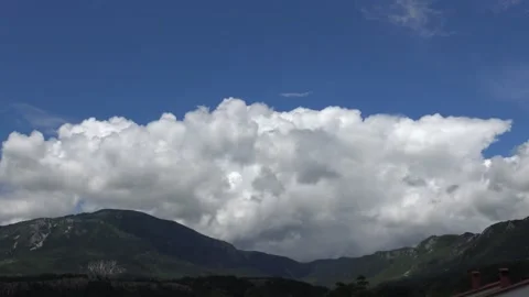 Soft white clouds over a mountain timelapse Stock Footage 159075268