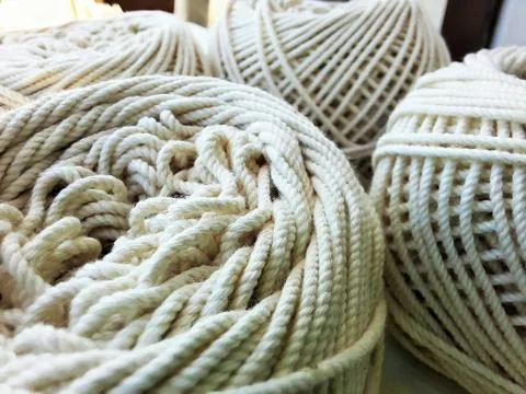 Soft white cotton thread roll with selective focus Stock Photos