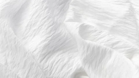 Soft white crinkle fabric background with abstract elegant folds Stock Photos