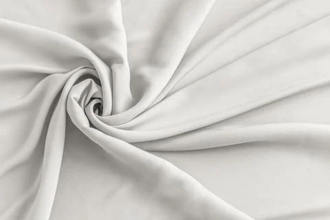 Soft white fabric draped in elegant folds for a clean minimalist backdrop Foto stock