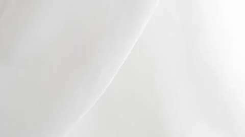 Soft white fabric draping elegantly with gentle folds and textures Stock Photos