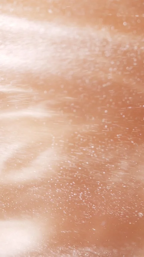Soft white particles drifting across warm sepia surface Video stock 343938615