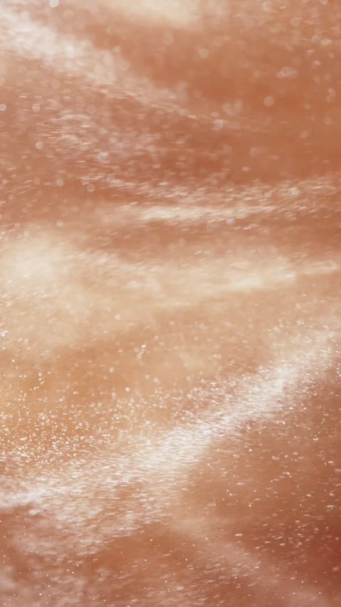 Soft white particles swirling dynamically over rich brown background Stock Footage 343938632