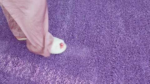 Soft white slippers on the violet Interior pile carpet. Video stock 309408740