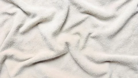 Soft white terry cloth texture folds luxuriously in macro closeup evoking ser Stock Photos