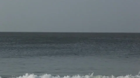 Soft, wide, straight shot of waves crashing and ocean next to Om Beach, India Stock Footage 33567203