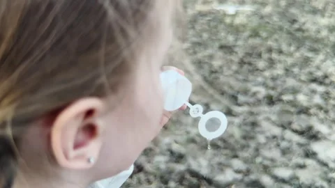 Soft wind carrying soap bubbles away, girl enjoying a peaceful evening Stock Footage 316178991