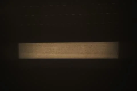 Soft window light casts a beam and shadow across a minimal interior surface.. Stock Photos