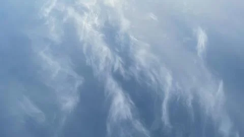 Soft, wispy cirrus clouds in a vast blue sky. Ideal for a serene nature bac.. Stock Photos
