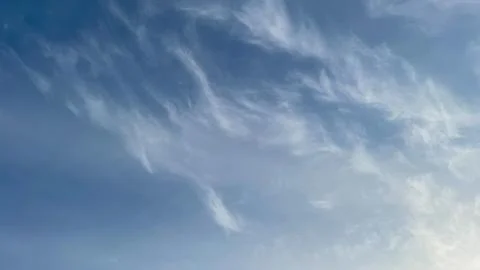 Soft, wispy cirrus clouds in a vast blue sky. Ideal for a serene nature bac.. Stock Photos