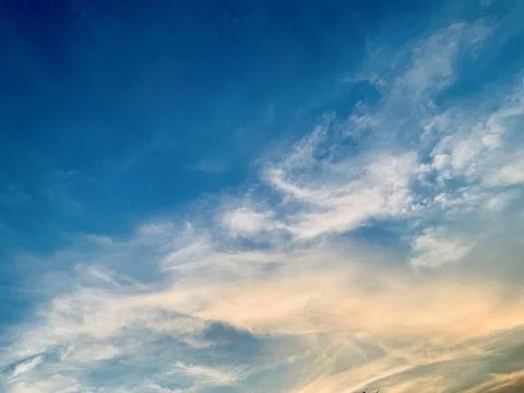 Soft Wispy Clouds in Blue Sky with Warm Golden Sunlight Image Jakarta Indonesia Stock Photos