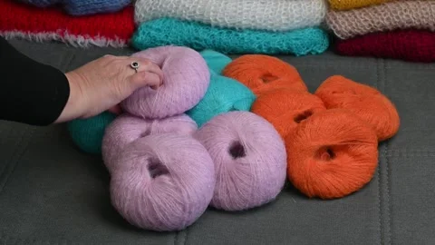 Soft wool yarn balls piled up, colorful knitting supplies for craft projects. Stock Footage 334749429
