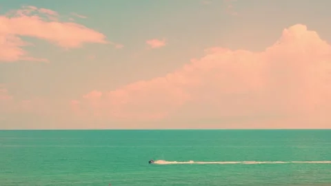 Soft Yellow Blue Sky Clouds Sun over the Sea and Motor Boat at Sunset. Colorful  Stock-Footage 319642667