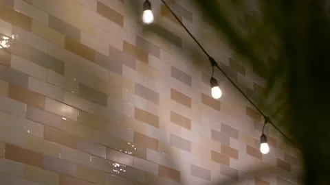 Soft yellow bulbs blowing in the wind brick background creepy shadows 스톡 동영상 160073367