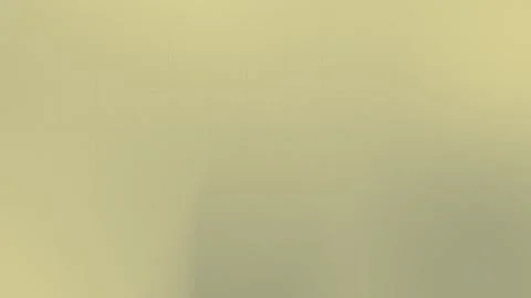 Soft yellow seamless loop background with subtle grid pattern. 4K. Stock Footage 309058590