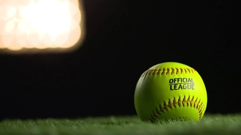 A softball spins under the stadium lights. Stock Footage 72356944
