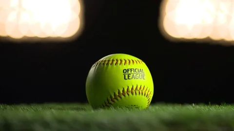 A softball spins under the stadium lights. Stock Footage 72357146