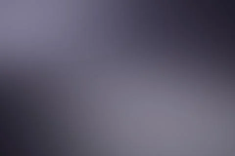 A softly blurred abstract background blends charcoal, gray, and muted purpl.. Ilustração Stock