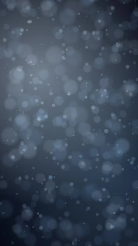 Softly blurred bokeh lights drift downward against a dark blue gradient Vídeo Stock 345185796