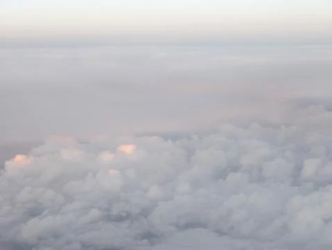 Softly glowing clouds drifting across sky, bright clouds gently glow as the.. Stock Photos