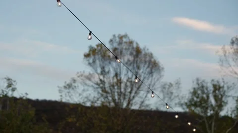 Softly Glowing String Lights Cast Romantic Atmosphere Ideal For Outdoor Stock Footage 323770625