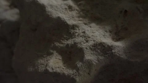 Softly lit rock surface with textured crevices. Stock Footage 289845040