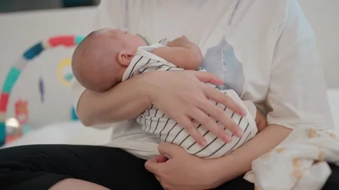 Softly sleeping infant rests in parent's arms Stock Footage 340312491