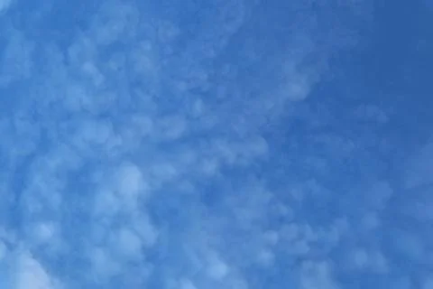 Softly Textured Altocumulus Clouds Spread Across the Azure Sky Stock Photos