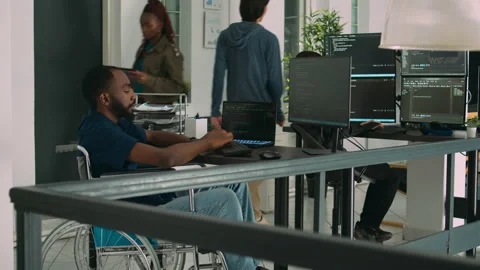 Software app coder in wheelchair writing programming language on computer Stock Footage 231448495