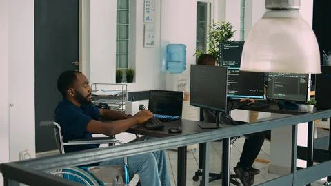 Software app coder in wheelchair writing programming language on computer 写真素材