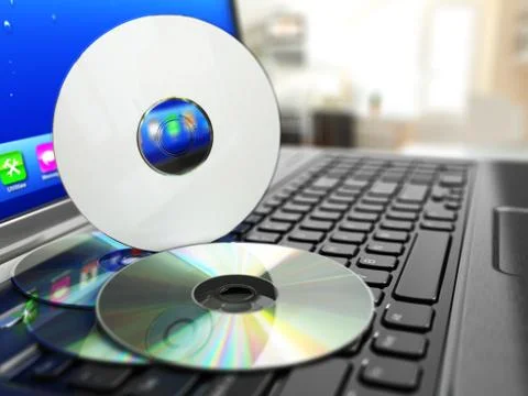 Software cd on laptop keyboard. compact disks. Stock Illustration