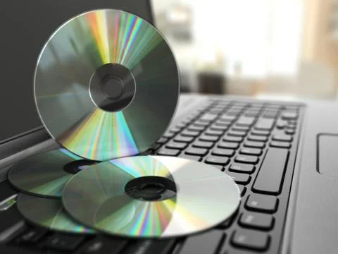 Software cd on laptop keyboard. compact disks. Stock Illustration