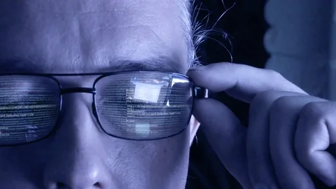 Software code reflecting in hackers glasses Stock Footage 93036292