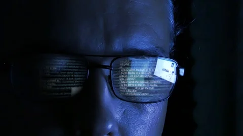 Software code reflecting in hackers glasses Stock Footage 93047032
