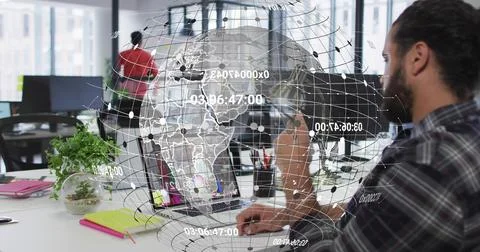 Software coder wearing flannel typing on laptop at office desk, with holographic Stock Photos