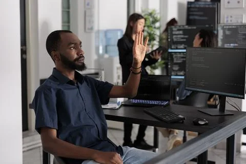 Software developer analysing ar hologram to work on html code Stock Photos