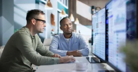 Software Developer Analyzing API Gateway Traffic Data On Desktop Computer. Stock Photos