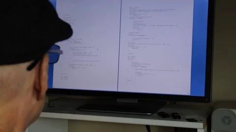 A software developer analyzing computer code at home Stock Footage 227154832