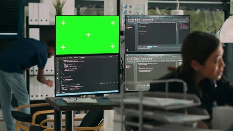 Software developer analyzing greenscreen and server code on multiple monitors Stock Footage 217409597