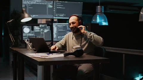 Software developer attending online videocall conference on laptop Stock Photos