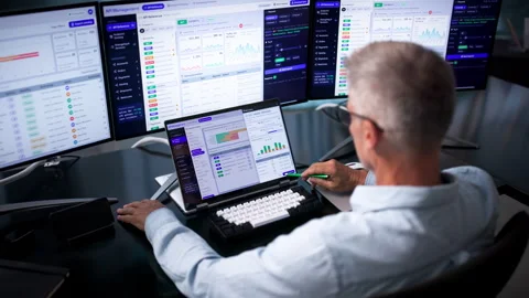Software Developer Carefully Monitors API Gateway Traffic On Laptop Stockbeeldmateriaal 343883551