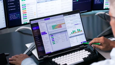 Software Developer Carefully Monitors API Gateway Traffic On Laptop Vídeo Stock 343883982