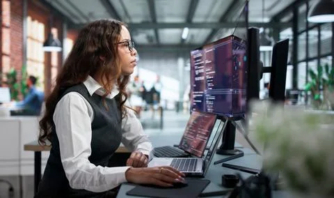 Software Developer Carefully Types Secure Code On Laptop During Remote Teamwo Foto stock