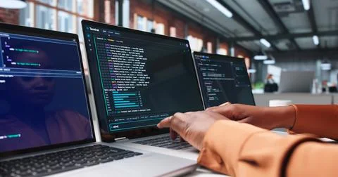Software Developer Carefully Writes Secure Code On Laptop Using Online Tools. Stock Photos
