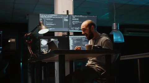 Software developer celebrating coding achievement and typing programming code Stockfoto's