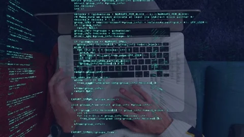 Software developer checking handheld device as green code overlay appears, then Stock Footage 334728796